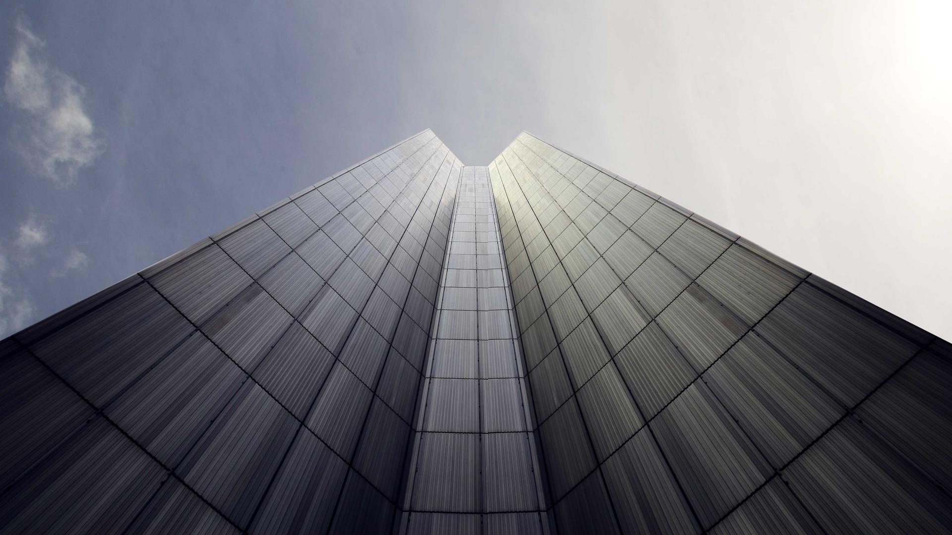 Editorial context photo looking toward the top of a glass skyscraper